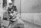 Audrey Hepburn in Grey Turtleneck Sweater, Glances Left with Smoke, 1953