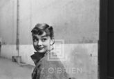Audrey Hepburn in Grey Turtleneck Sweater, Glances Back Grinning, 1953