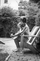 Kennedy, Jackie Helps Caroline with Shoe, 1959