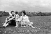 Kennedys, Caroline Feeds Flower to John, Jackie Looks on, 1959