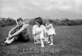 Kennedys, Hyannis Beach, John Smiling, Jackie and Caroline Look at John, 1959