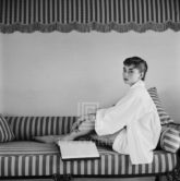 Audrey Hepburn on Striped Sofa, Hugs Knee,1954