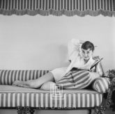 Audrey Hepburn on Striped Sofa, Arm Back, Smiling, 1954