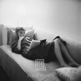 Audrey Hepburn Supine Reading on Couch, 1953